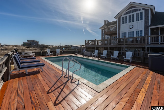 view of swimming pool with a fenced in pool and a wooden deck