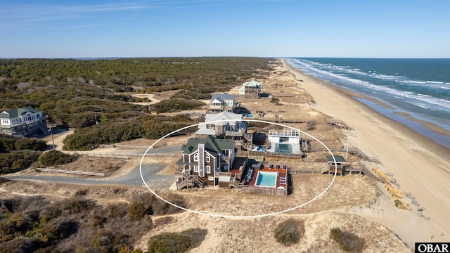 aerial view featuring a water view and a view of the beach