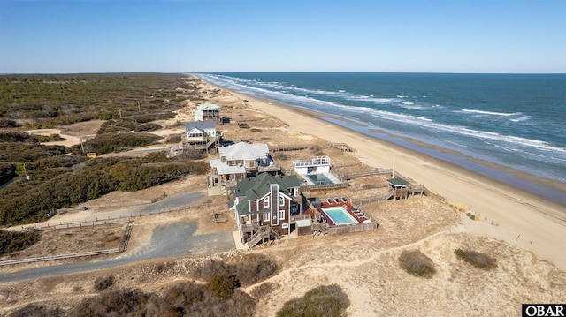 bird's eye view with a water view and a beach view