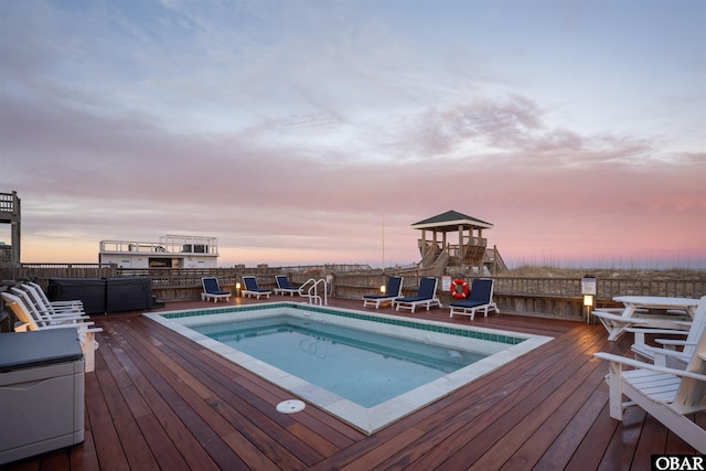 view of pool with a covered hot tub and a wooden deck