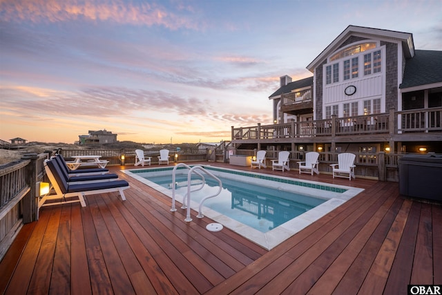 view of swimming pool with a deck and a fenced in pool