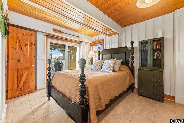 bedroom with beamed ceiling, light tile patterned flooring, wooden ceiling, and access to exterior