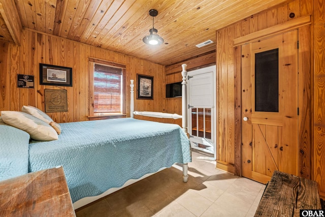 bedroom featuring visible vents, light tile patterned flooring, wood ceiling, and wooden walls