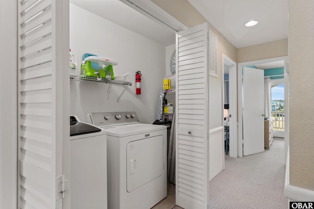 laundry room featuring recessed lighting, laundry area, light colored carpet, and washing machine and clothes dryer