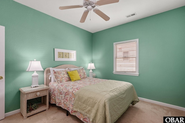 bedroom featuring baseboards, visible vents, and light colored carpet