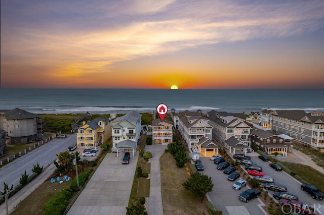 drone / aerial view with a residential view and a water view