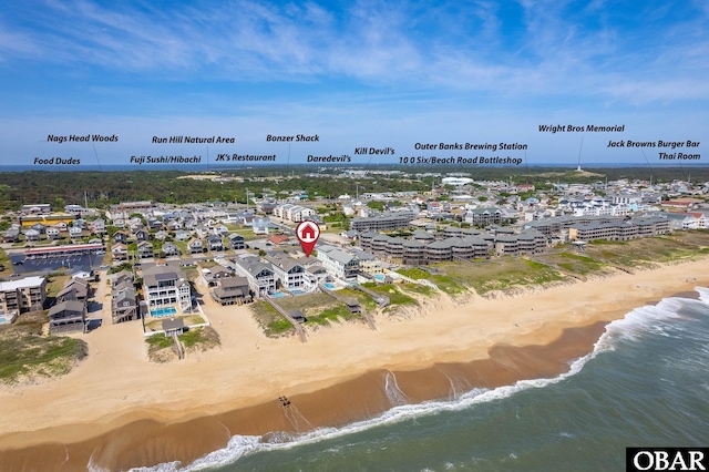 birds eye view of property with a beach view and a water view