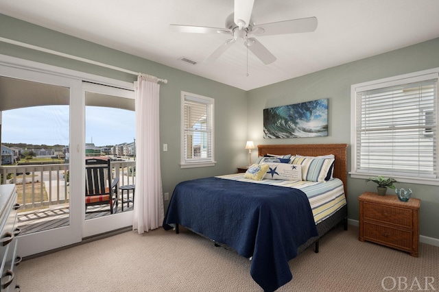 bedroom featuring light colored carpet, a ceiling fan, baseboards, visible vents, and access to outside