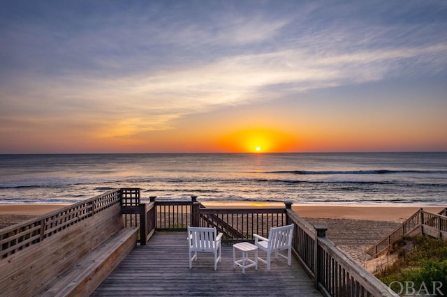 view of dock with a view of the beach and a deck with water view