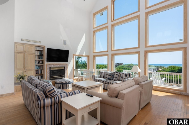 385 Deep Neck Rd Lot # 131, Corolla, NC 27927 - living area with a high ceiling, a fireplace, and light wood-type flooring