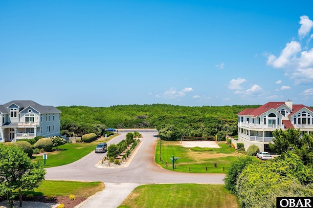 385 Deep Neck Rd Lot # 131, Corolla, NC 27927 - view of home's community featuring a forest view and curved driveway