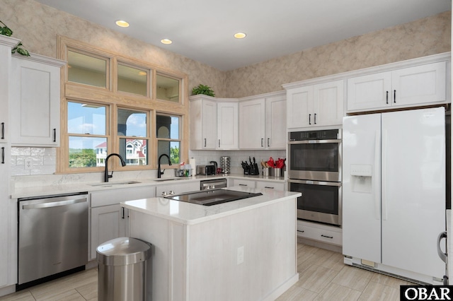 385 Deep Neck Rd Lot # 131, Corolla, NC 27927 - kitchen with appliances with stainless steel finishes, decorative backsplash, white cabinets, a center island, and recessed lighting