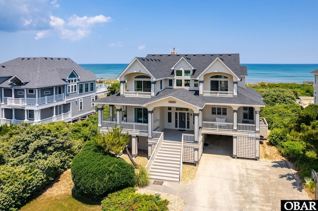 385 Deep Neck Rd Lot # 131, Corolla, NC 27927 - view of front of home featuring a porch, a water view, concrete driveway, stairway, and a balcony
