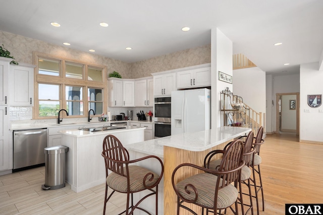 385 Deep Neck Rd Lot # 131, Corolla, NC 27927 - kitchen featuring stainless steel appliances, a center island, light wood-style flooring, a breakfast bar, and recessed lighting