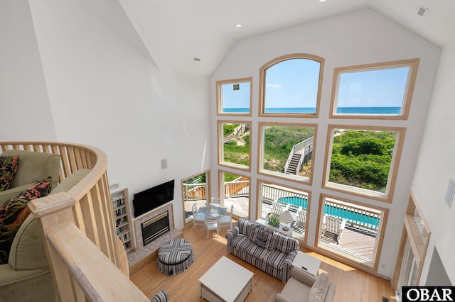 385 Deep Neck Rd Lot # 131, Corolla, NC 27927 - living room featuring high vaulted ceiling, wood finished floors, and a glass covered fireplace