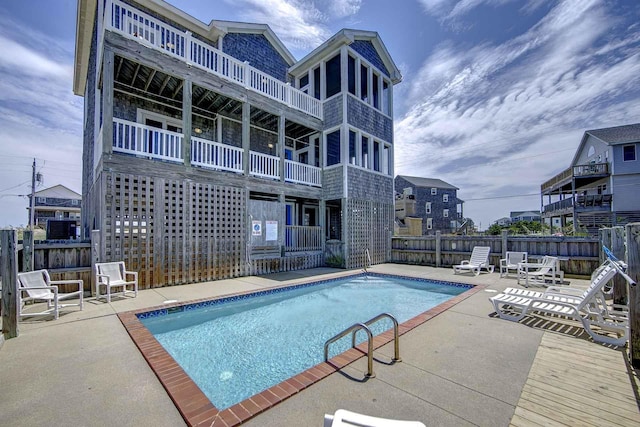 community pool featuring a patio area and fence