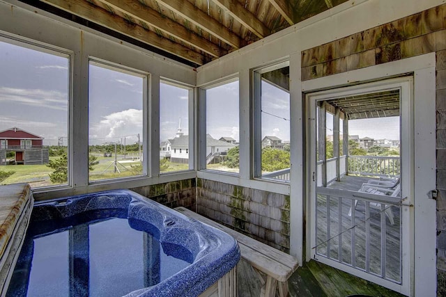 sunroom / solarium with a hot tub