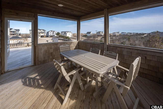 wooden terrace featuring a residential view and outdoor dining space