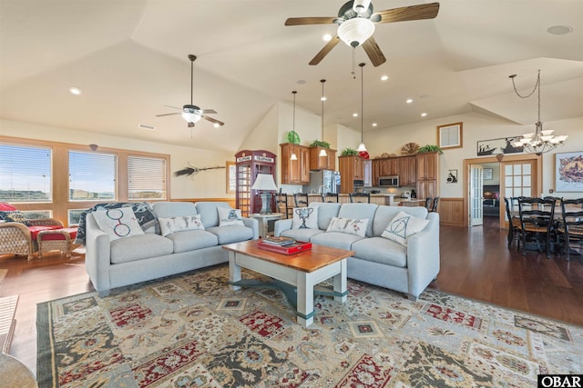 living room with ceiling fan with notable chandelier, wainscoting, wood finished floors, and visible vents