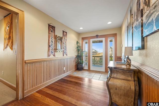 entrance foyer featuring wainscoting and wood finished floors