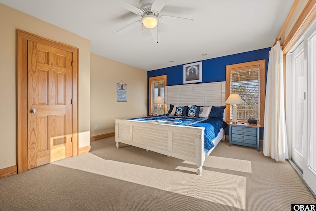 carpeted bedroom featuring baseboards and ceiling fan