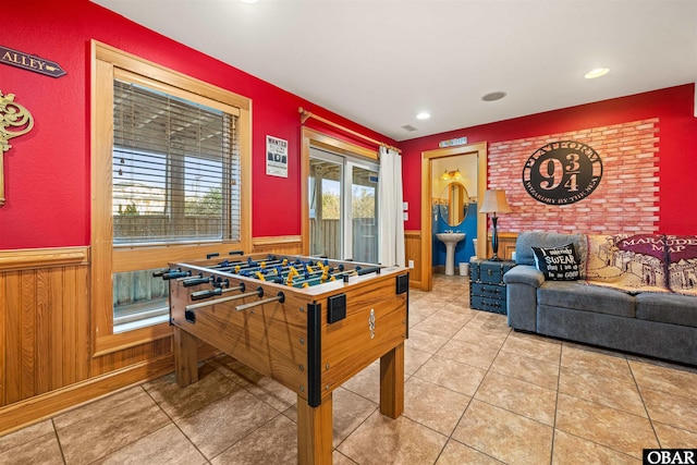 rec room with wainscoting, tile patterned floors, wooden walls, and recessed lighting