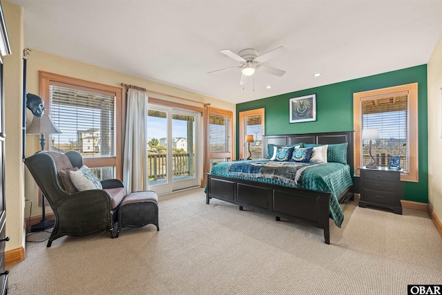 bedroom with multiple windows, a ceiling fan, carpet floors, and access to exterior