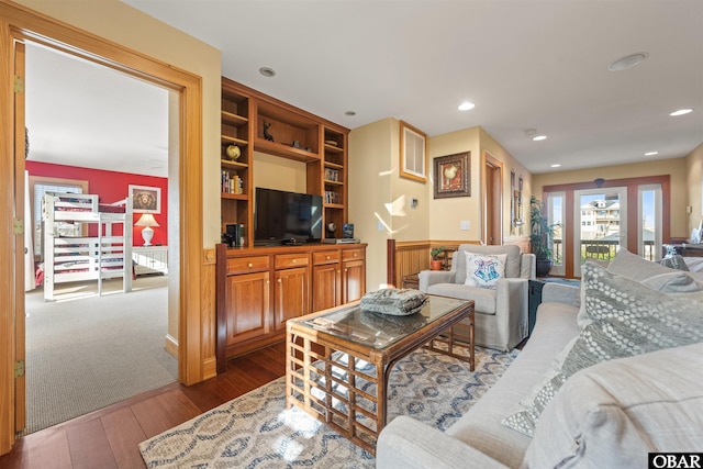 living area with hardwood / wood-style floors and recessed lighting