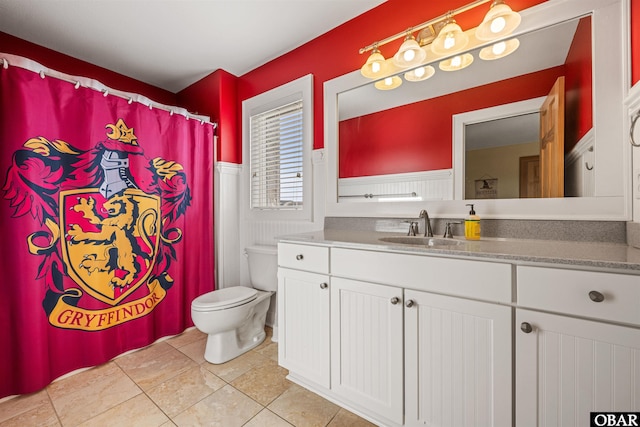 bathroom featuring tile patterned flooring, toilet, and vanity