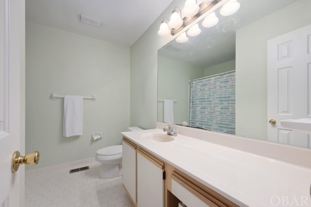 bathroom featuring visible vents, toilet, tile patterned flooring, and vanity