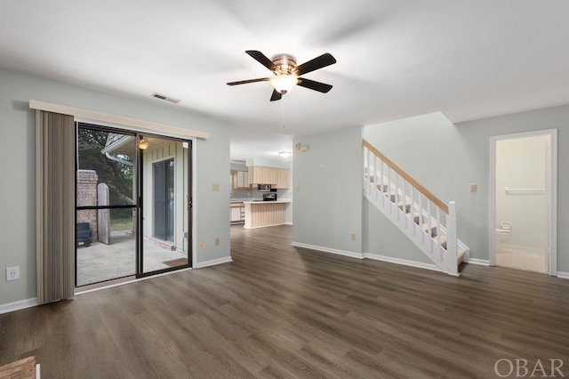 unfurnished living room with visible vents, stairway, dark wood finished floors, and baseboards