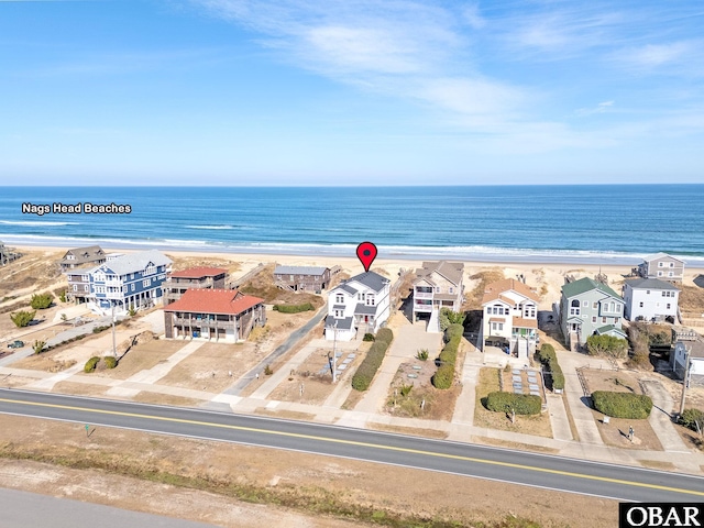 bird's eye view featuring a water view, a residential view, and a view of the beach