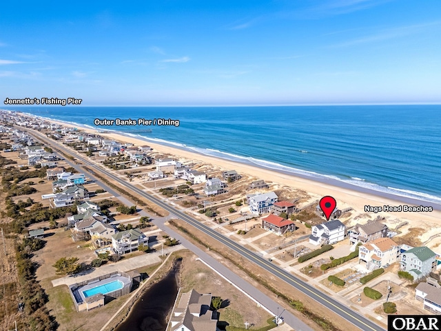 birds eye view of property with a beach view and a water view