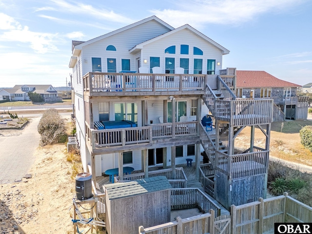 exterior space with fence, stairway, a wooden deck, and central AC unit