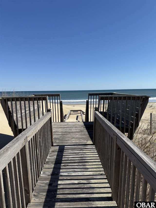 view of home's community with a beach view and a water view