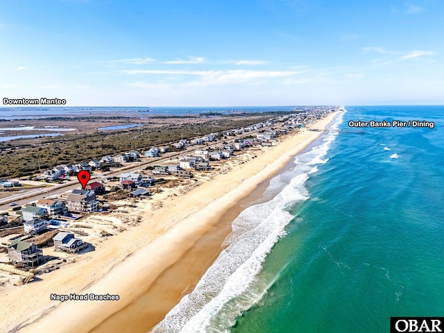 birds eye view of property featuring a water view and a view of the beach