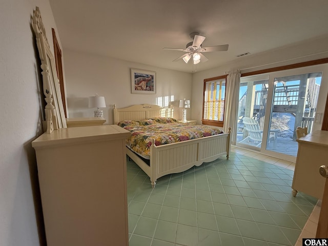 bedroom with light tile patterned floors, a ceiling fan, visible vents, and access to exterior