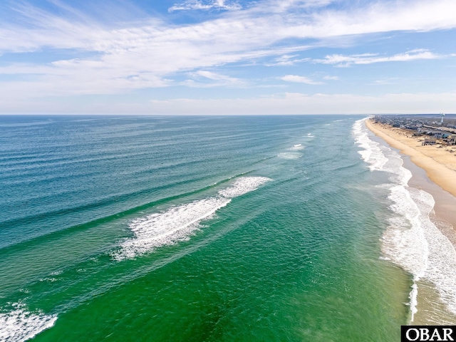 aerial view with a water view and a beach view