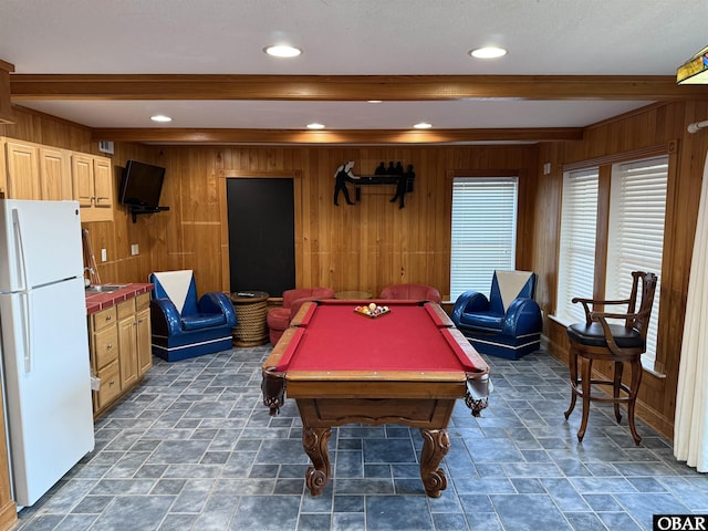 recreation room featuring pool table, beamed ceiling, stone finish flooring, and wooden walls