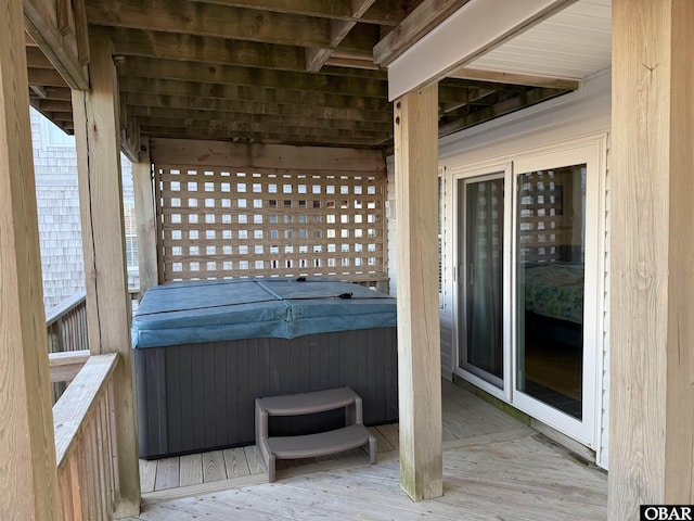 wooden deck with a hot tub