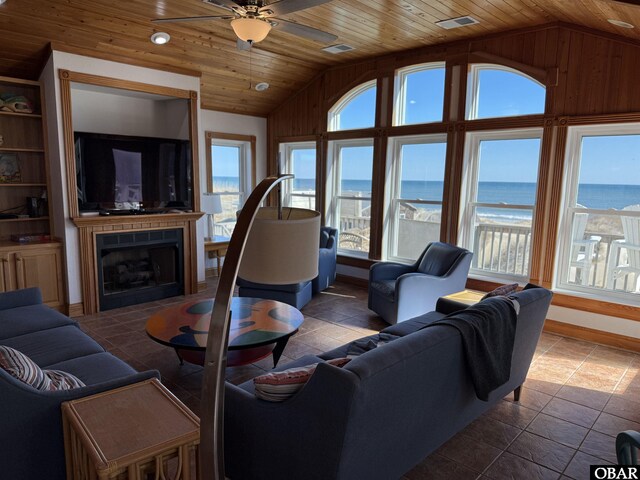 living area with lofted ceiling, plenty of natural light, wood ceiling, and a fireplace