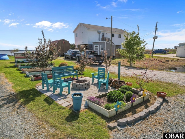 view of yard with a fire pit and a garden