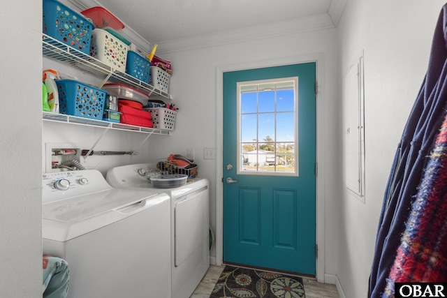 laundry room featuring washing machine and clothes dryer, ornamental molding, and laundry area
