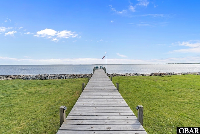 dock area featuring a yard and a water view