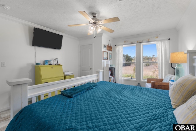 bedroom featuring a ceiling fan, wood finished floors, a textured ceiling, and crown molding