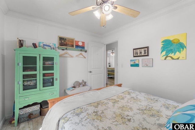 bedroom featuring wood finished floors, crown molding, and ceiling fan