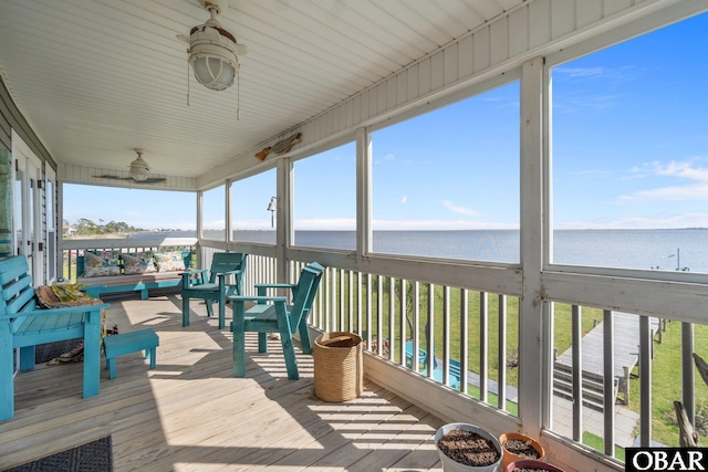 sunroom featuring a water view and a healthy amount of sunlight
