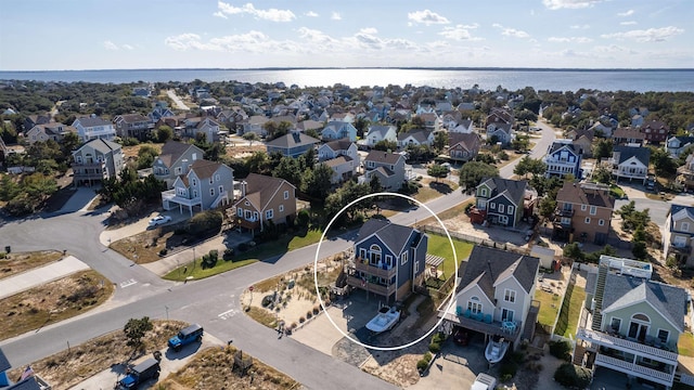 drone / aerial view featuring a water view and a residential view