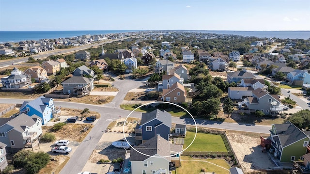 birds eye view of property with a water view and a residential view