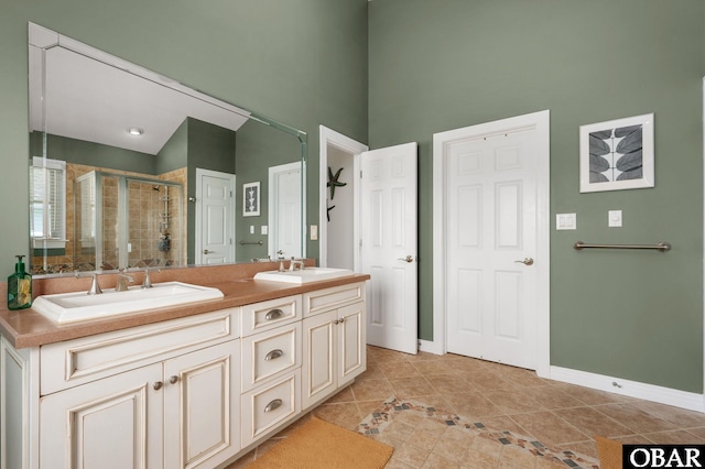 747 Hammock Ln Lot 55, Corolla, NC 27927 - full bath featuring tile patterned floors, double vanity, a stall shower, and a towering ceiling